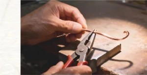 Silversmith bending wire with pliers